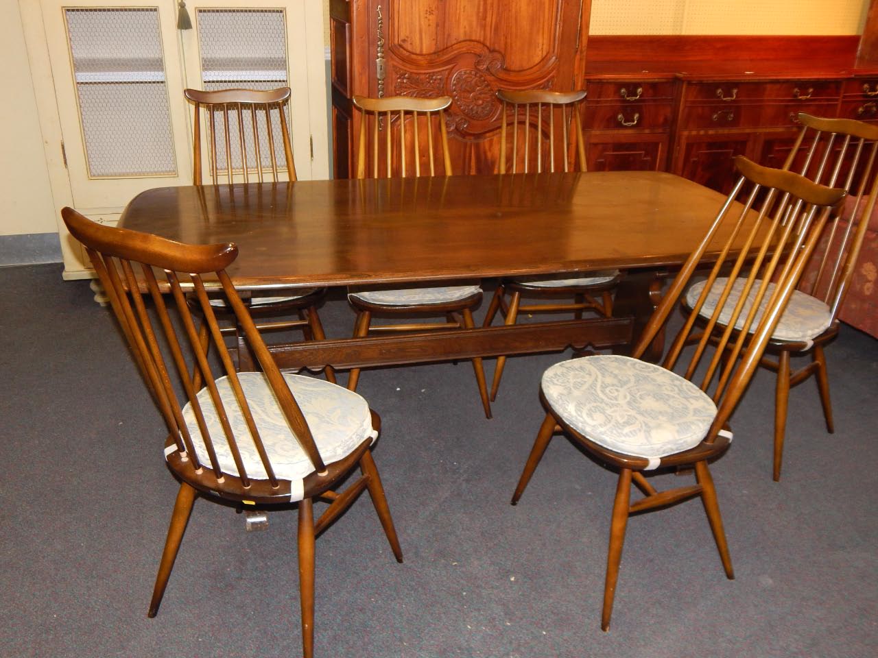 Appraisal: An Ercol mid coloured elm refectory type table on end