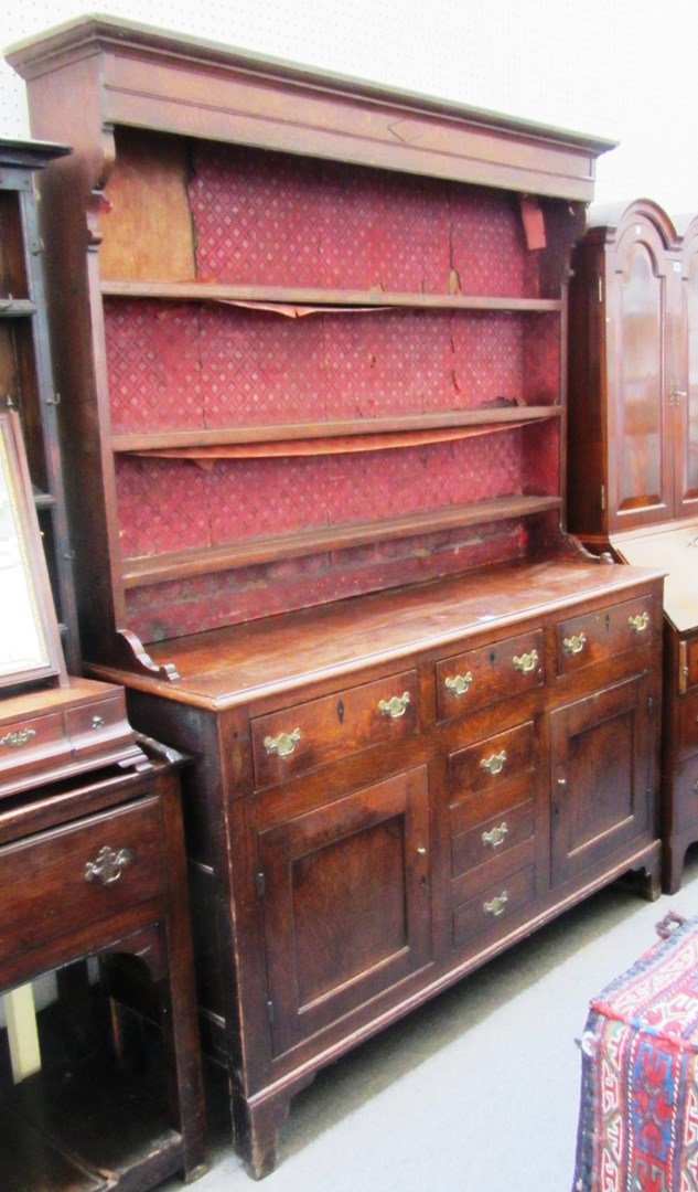 Appraisal: A George III oak dresser the enclosed three tier plate