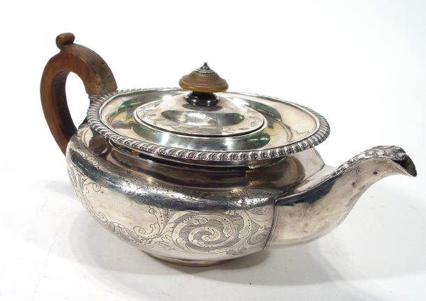 Appraisal: Circular Georgian silver teapot with chased decoration London cm high