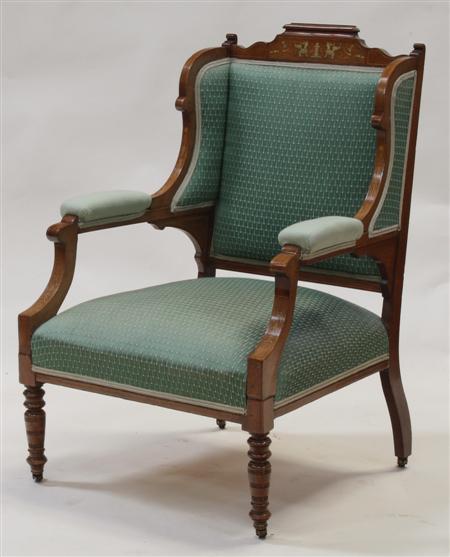 Appraisal: A Victorian rosewood and inlaid wing back armchair the shaped