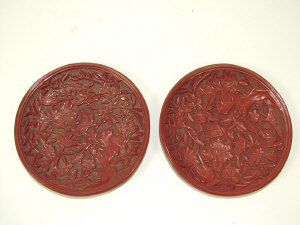 Appraisal: A pair of Chinese cinnebar lacquer circular dishes decorated with