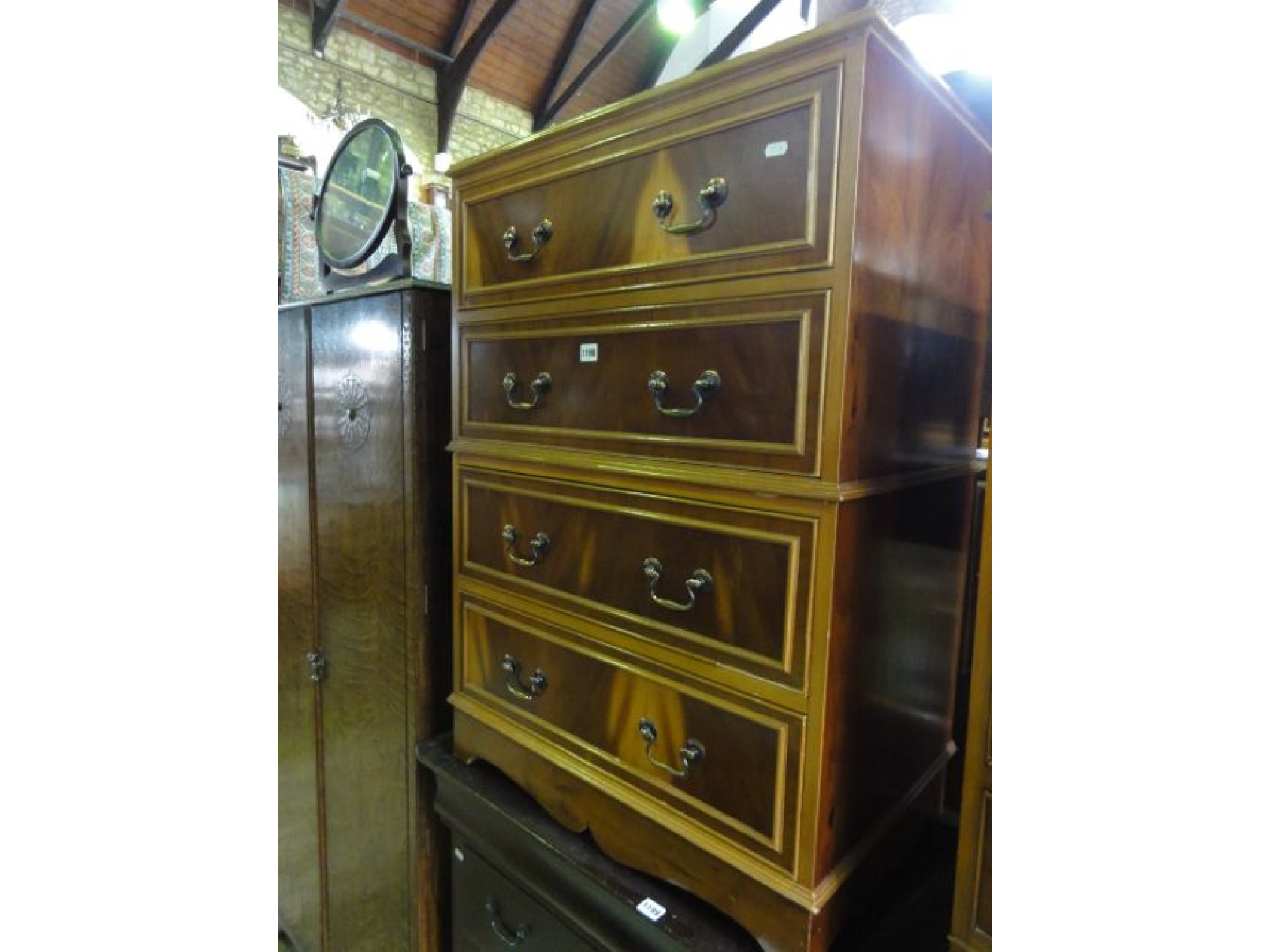 Appraisal: A reproduction yew wood veneered four drawer chest in the