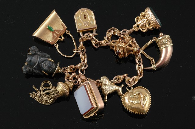 Appraisal: A GOLD CHARM BRACELET The fancy double link ct gold