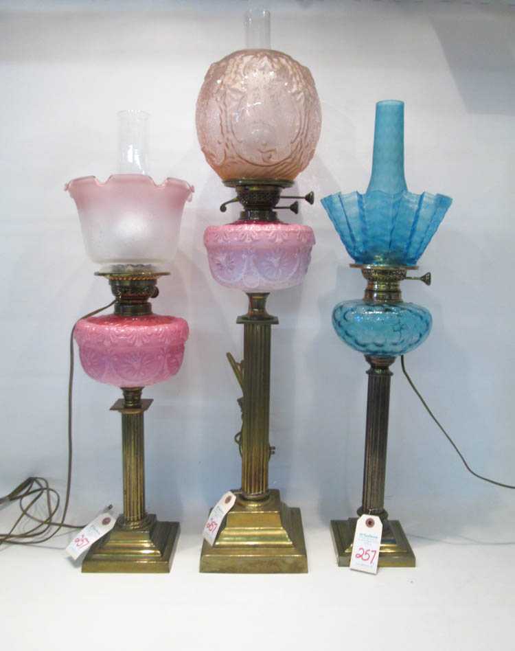 Appraisal: THREE ELECTRIFIED VICTORIAN FLUID OIL LAMPS the first lamp with