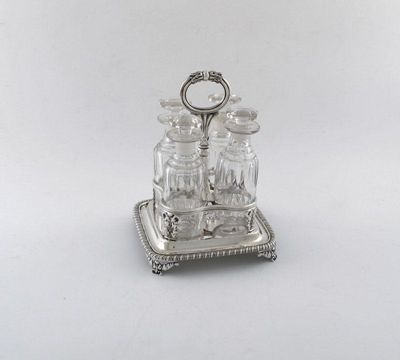 Appraisal: A George III four bottle cruet frame square form gadroon