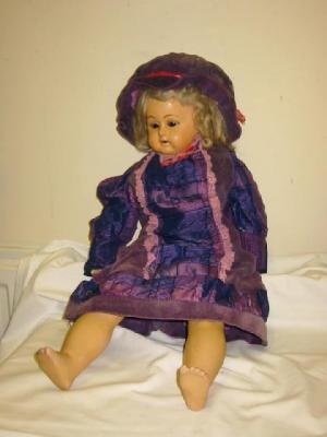 Appraisal: An early composition shoulder head doll with fixed brown eyes