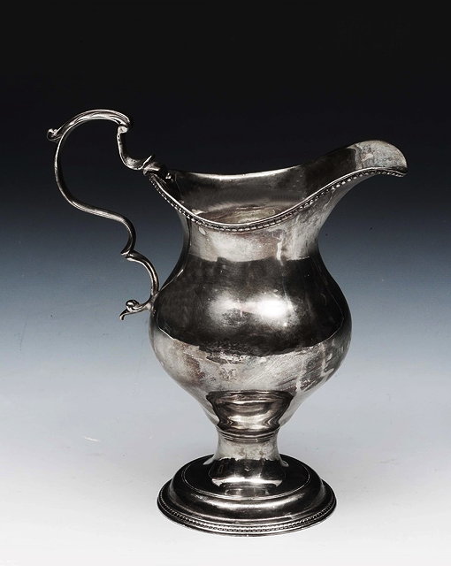 Appraisal: A GEORGE III SILVER BALUSTER SHAPE CREAM JUG with beaded