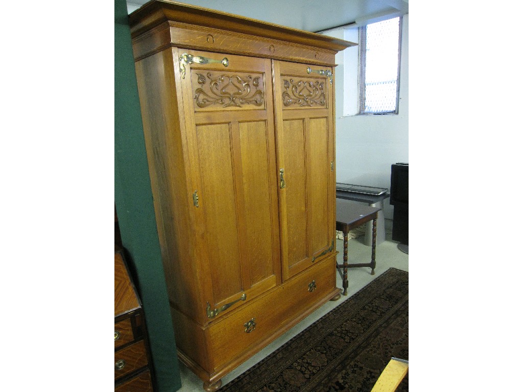 Appraisal: Art Nouveau carved oak wardrobe with beaten brass hinges