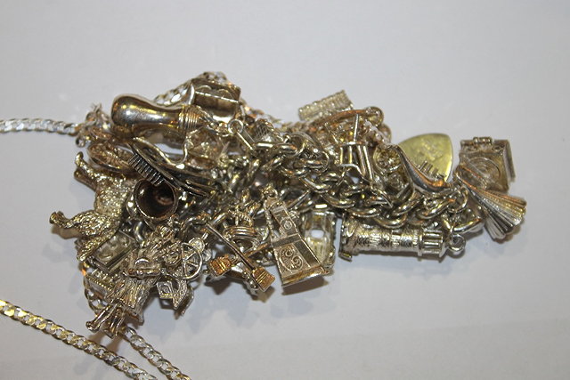 Appraisal: A WHITE METAL CHARM BRACELET fitted with a number of