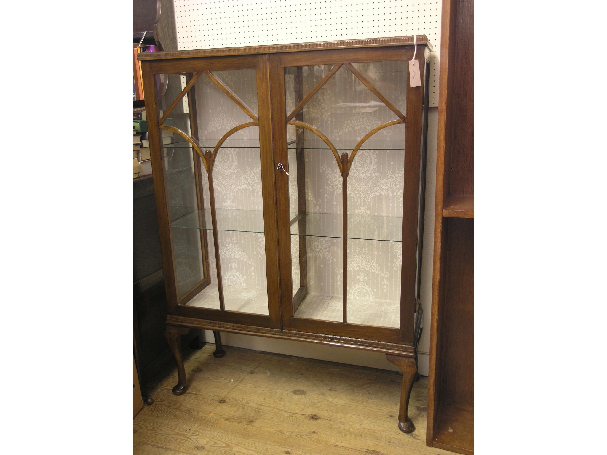 Appraisal: A walnut display cabinet pair of astragal-glazed doors enclosing four