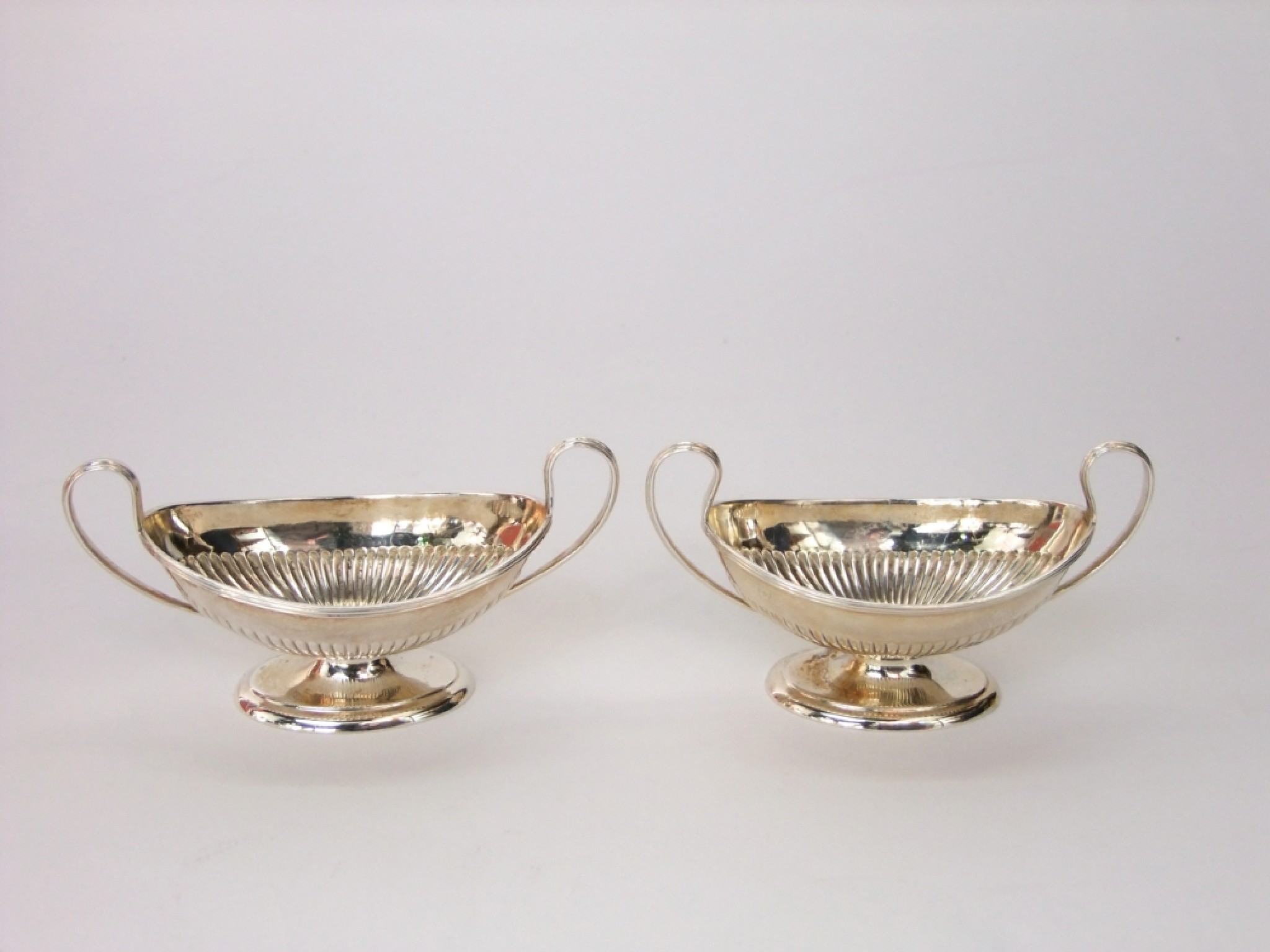 Appraisal: A pair of Georgian style open boat shaped salts with