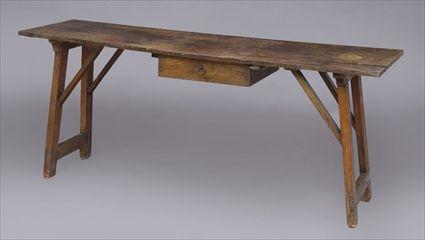 Appraisal: CONTINENTAL ELM TRESTLE TABLE The single plank top above a