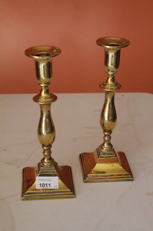 Appraisal: A pair of brass candlesticks cm high