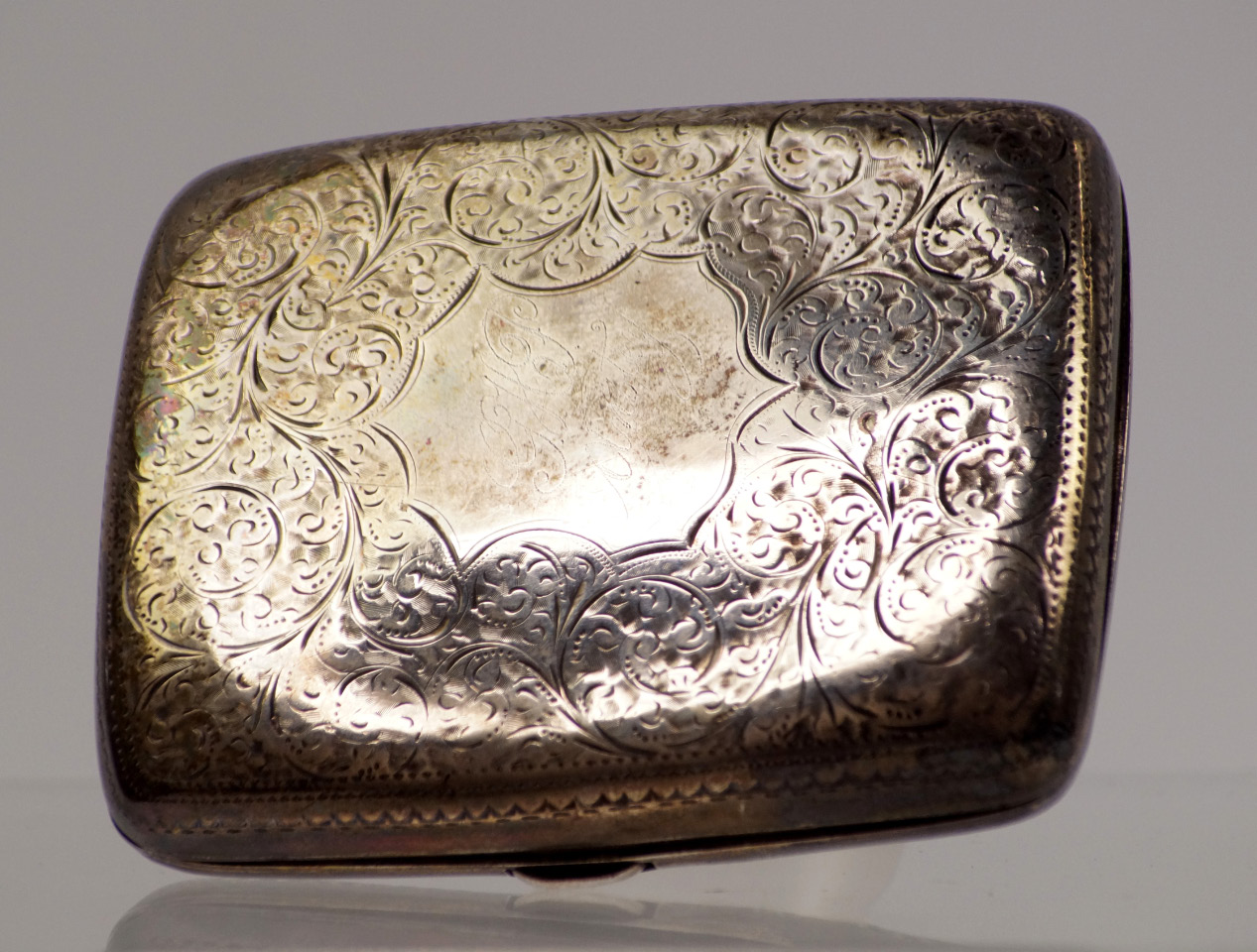 Appraisal: A late Victorian silver cigarette case with engraved scroll decoration