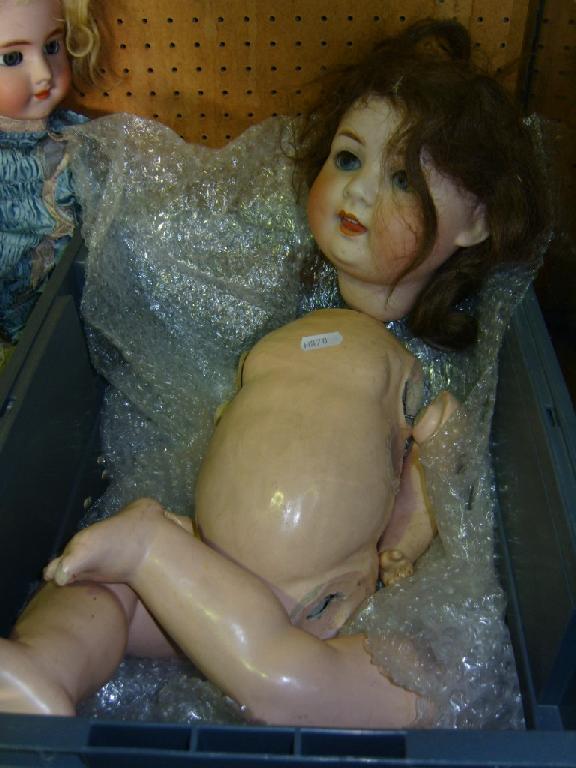 Appraisal: A German bisque headed doll with grey eyes open mouth