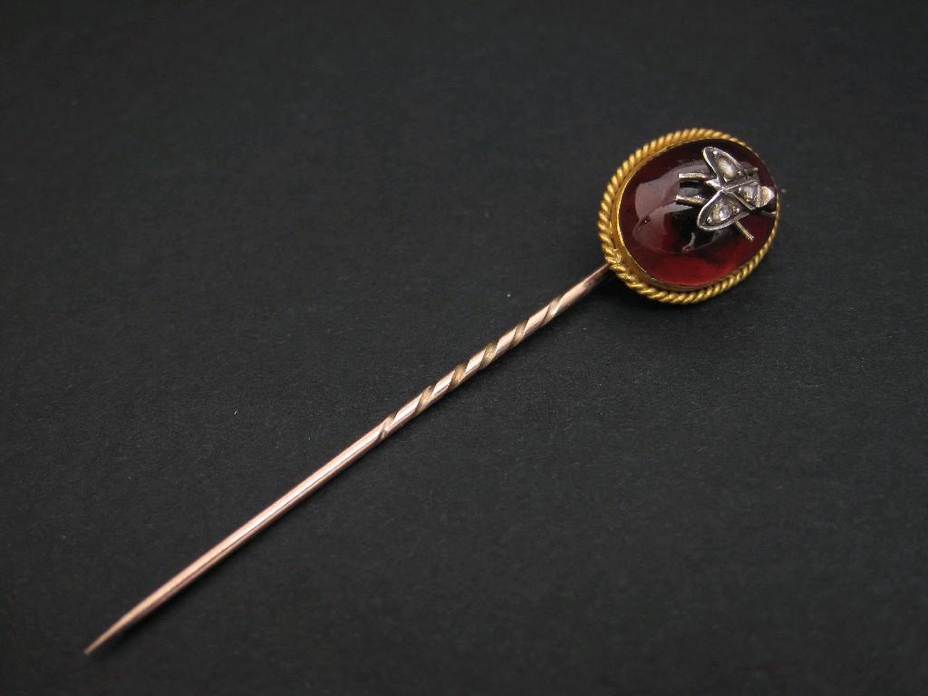 Appraisal: A Garnet and Diamond Stick Pin the oval garnet cabochon