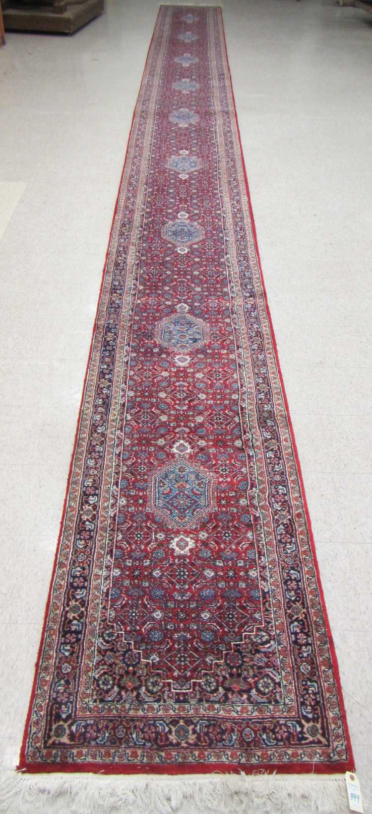 Appraisal: HAND KNOTTED ORIENTAL LONG RUG Indo-Bijar hexagonal medallion and Herati