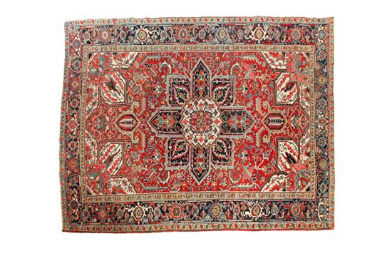 Appraisal: ORIENTAL RUG Heriz Red ground and white spandrels ' ''