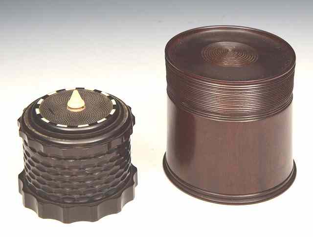 Appraisal: AN ORNAMENTALLY TURNED EBONY BOX with ivory finial and ivory