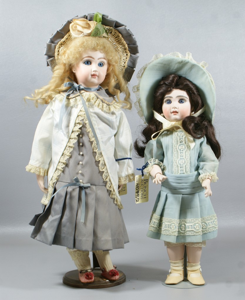 Appraisal: Reproduction Jumeau Dolls larger is on a cloth body with