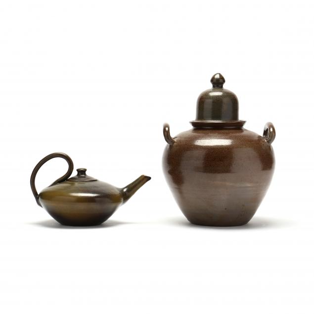 Appraisal: NC POTTERY ALADDIN TEAPOT AND LIDDED JAR The first an