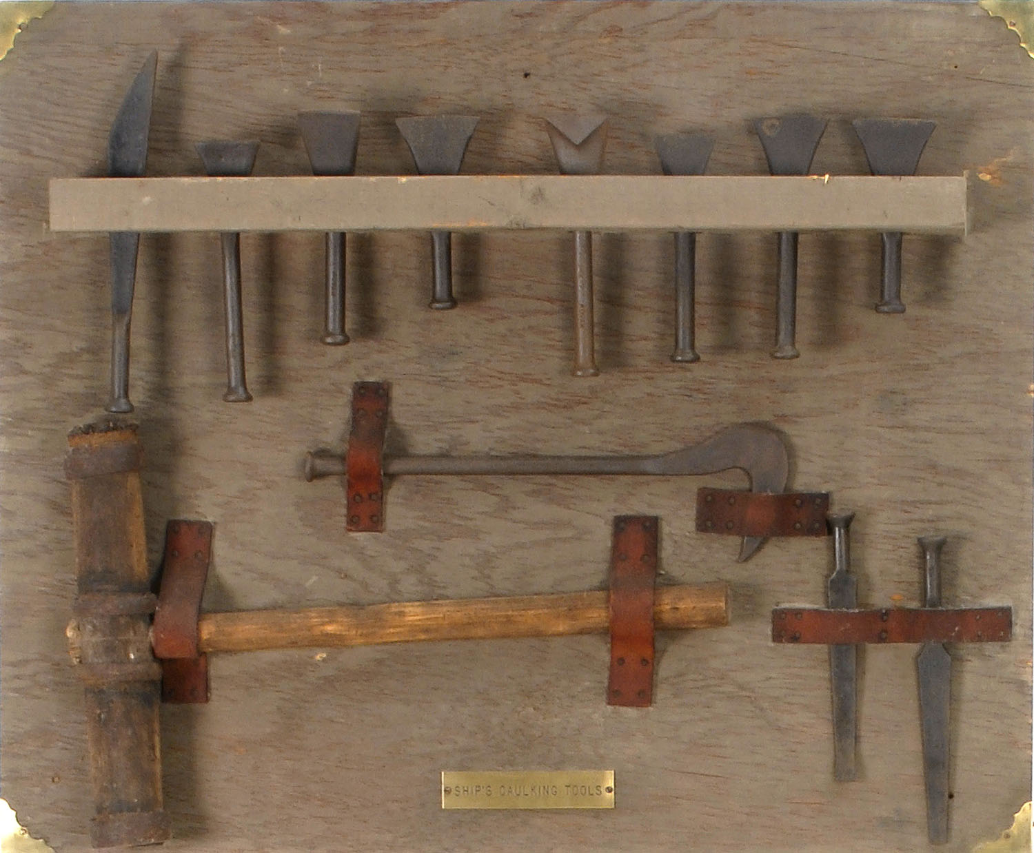 Appraisal: DISPLAY BOARD OF SHIP'S CAULKING TOOLS Includes twelve individual implements