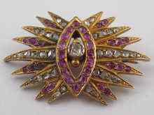 Appraisal: A gilt metal tests silver ruby and diamond brooch