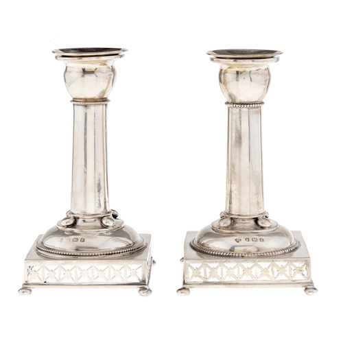 Appraisal: A pair of Edwardian silver dwarf columnar candlesticks on pierced