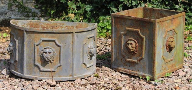 Appraisal: A CAST IRON SQUARE SECTION PLANTER with lion mask decoration