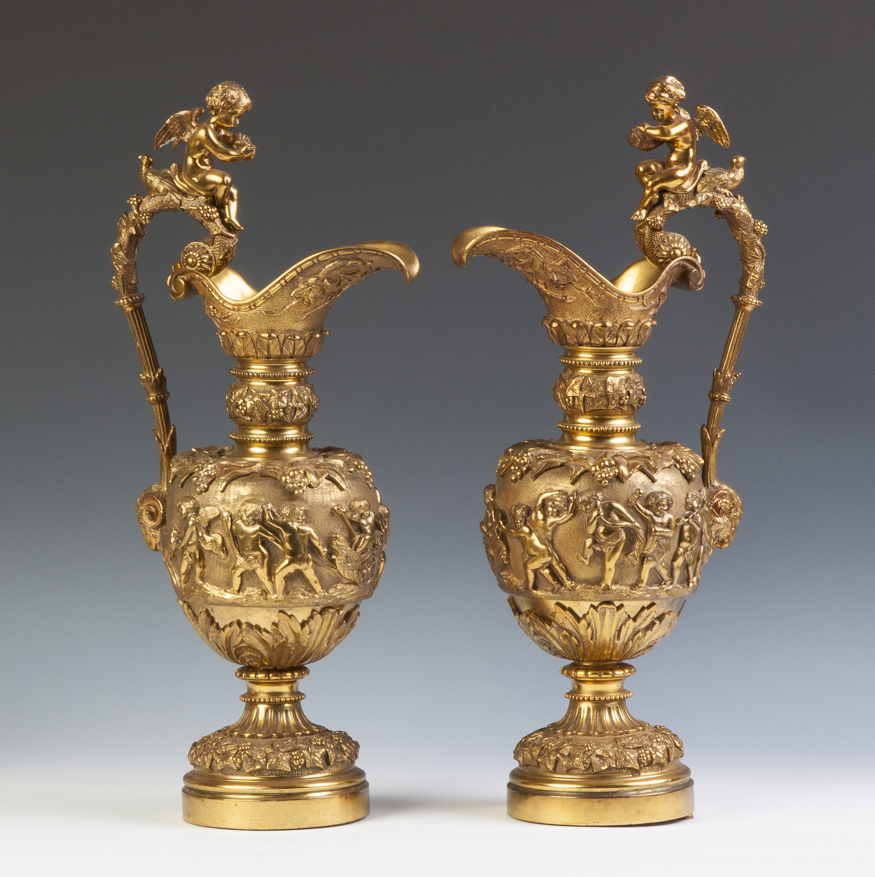 Appraisal: Pair of Gilt Bronze Ewers with Cherubs Rams Heads th