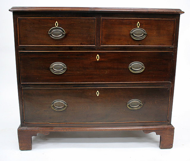 Appraisal: A GEORGIAN MAHOGANY STRAIGHT FRONT CHEST of two short and