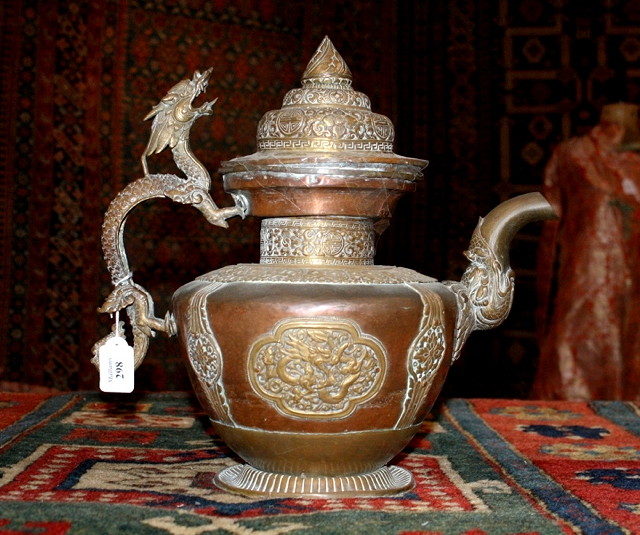 Appraisal: A TIBETAN COPPER AND BRASS EWER AND COVER with dragon