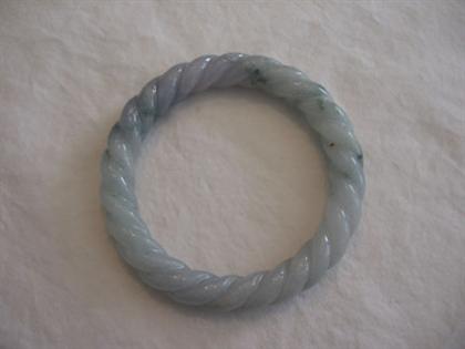 Appraisal: Carved jade bangle bracelet Light green and lavender jade carved