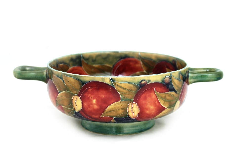 Appraisal: A William Moorcroft - Pomegranate ceramic twin handled bowl made