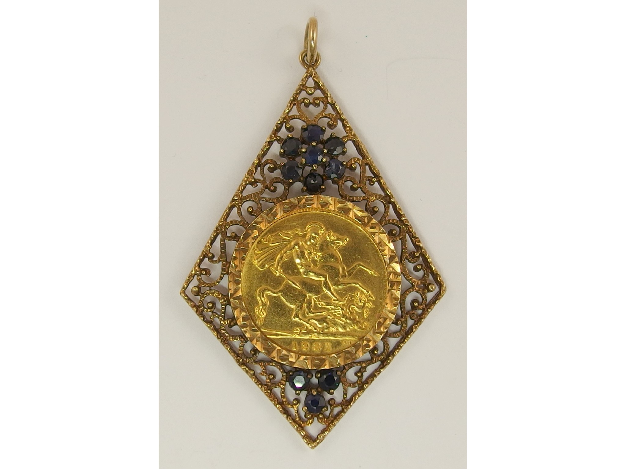 Appraisal: A gold full sovereignin ct filigree pendant mount with sapphire