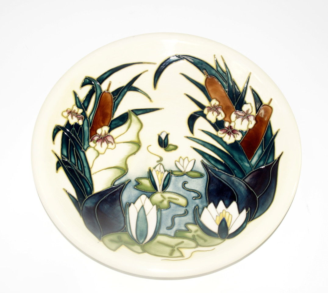 Appraisal: A Moorcroft pottery plate decorated with water lilies and bulrushes