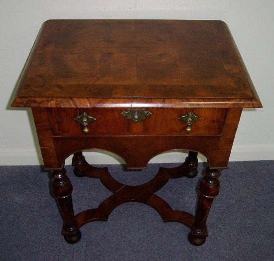 Appraisal: A walnut lowboy the rectangular crossbanded top over a single