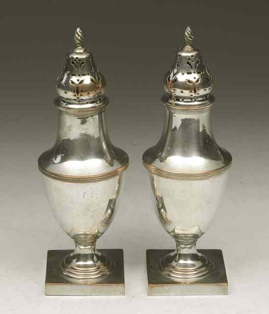 Appraisal: A PAIR OF BALUSTER SHAPED SILVER PLATED CASTORS standing on