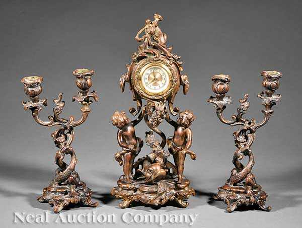 Appraisal: A Rococo-Style Bronze Three-Piece Figural Clock Garniture c case supported