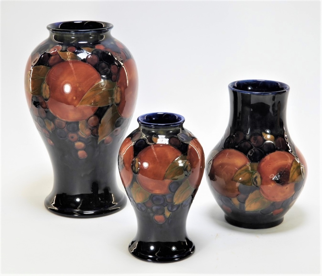 Appraisal: MOORCROFT POMEGRANATE PATTERN POTTERY VASES England th CenturyThree Moorcroft Pomegranate