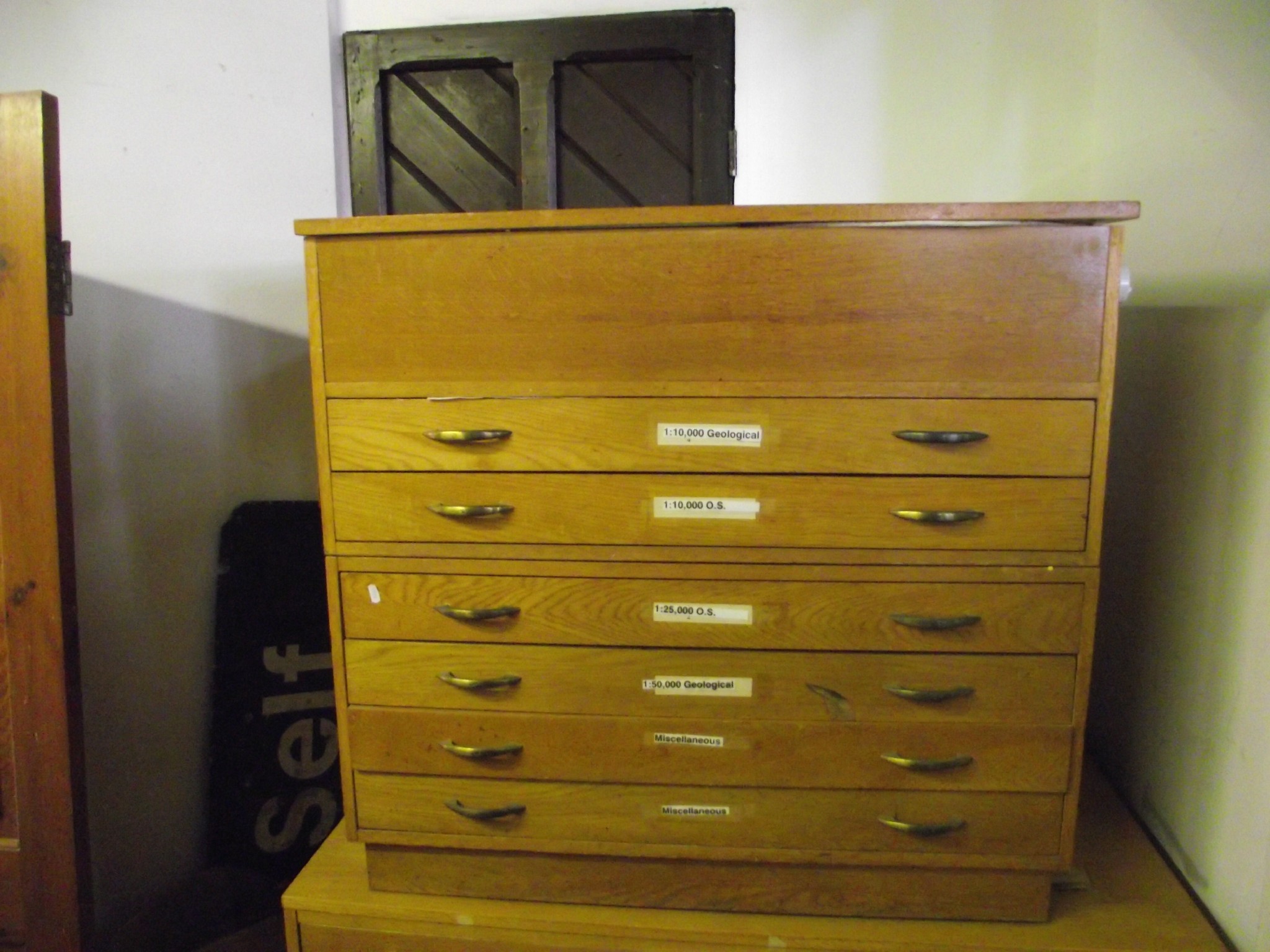 Appraisal: A light oak veneered two sectional and floorstanding plan chest