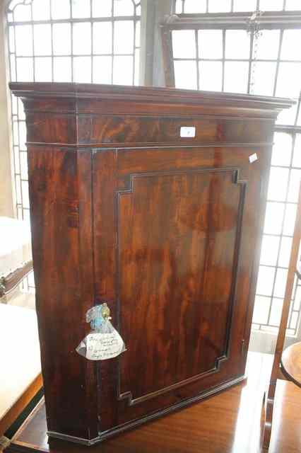 Appraisal: A GEORGE III MAHOGANY SMALL CORNER CUPBOARD with moulded single