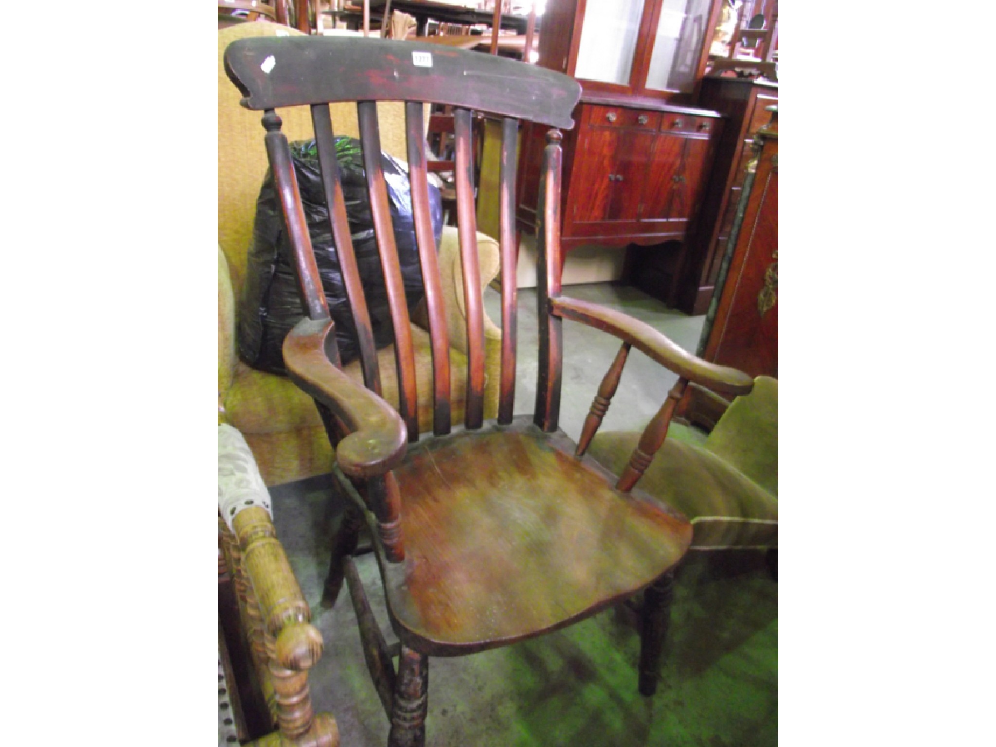 Appraisal: A Windsor lathe back elbow chair of usual form with