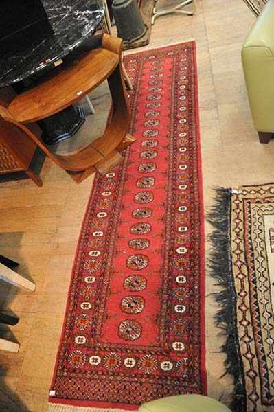 Appraisal: A PERSIAN RUNNER IN RED BLACK AND ORANGE TONES