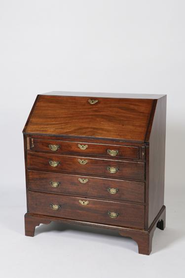 Appraisal: A GEORGE III MAHOGANY BUREAU with a sloping fall enclosing