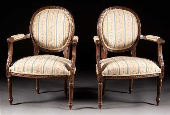 Appraisal: Pair of Louis XVI style carved fruitwood upholstered fauteuils th