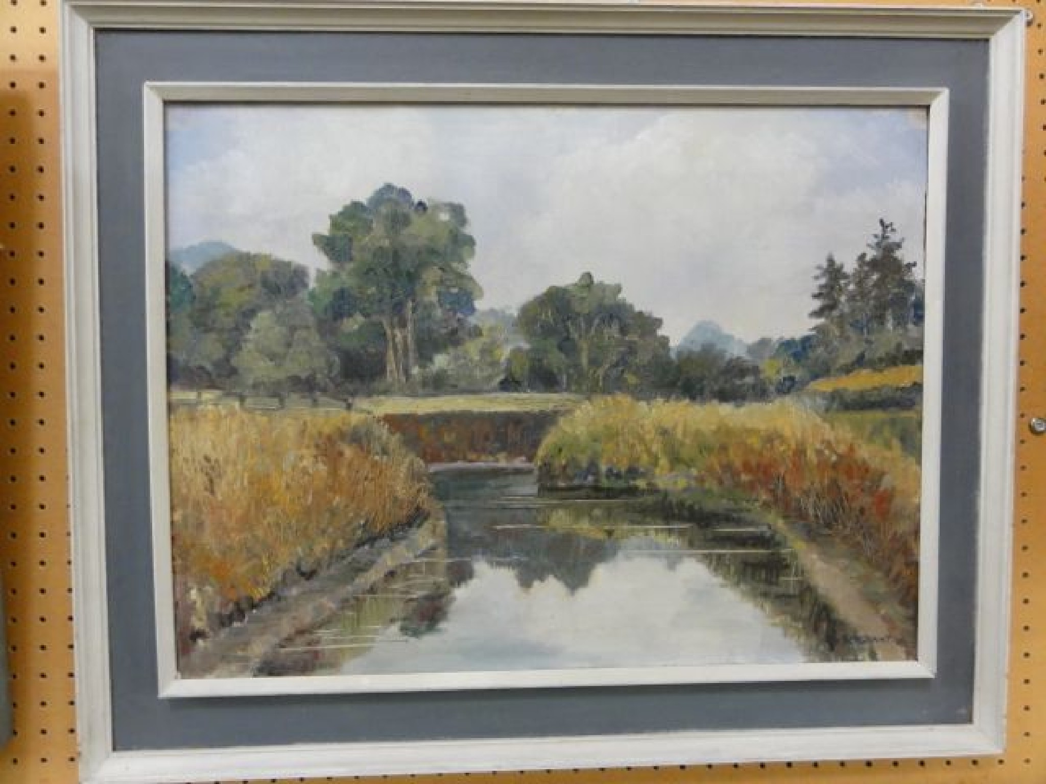 Appraisal: An oil painting on board of a river landscape signed