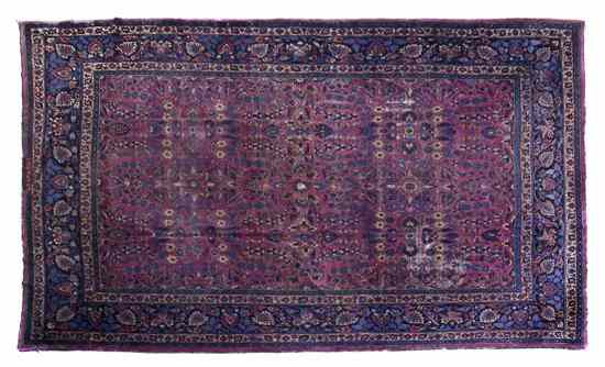 Appraisal: A Sarouk Wool Rug having allover foliate decoration on a