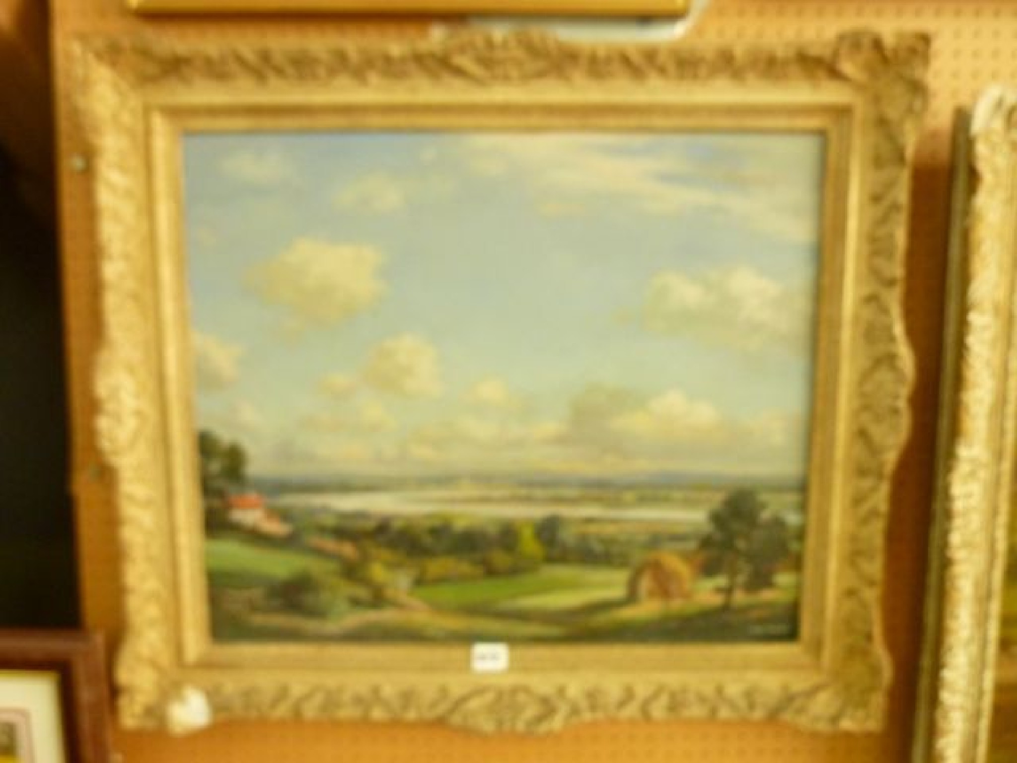 Appraisal: An oil painting on board of an extensive river landscape