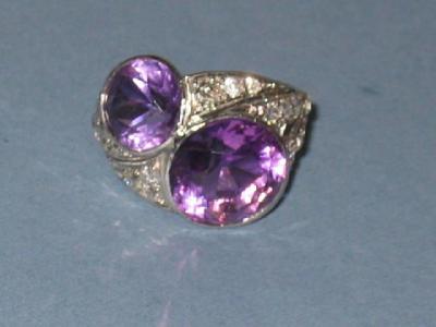 Appraisal: AN AMETHYST AND DIAMOND DRESS RING comprising two round cut